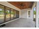 Covered patio with stone pavers, ceiling fan, and French doors at 109 November Dr, Durham, NC 27712
