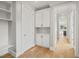 White hallway with built-in cabinets and hardwood floors at 109 November Dr, Durham, NC 27712