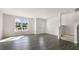 Spacious living room featuring gray flooring, large window, and stairway at 863 Old Tarboro Rd, Wendell, NC 27591