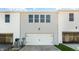 Rear view of townhome showing a double garage and additional storage at 863 Old Tarboro Rd, Wendell, NC 27591