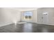 Bright living room with hardwood floors, large window, and view of backyard at 859 Old Tarboro Rd, Wendell, NC 27591