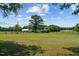 Open farmland with a home and barn in the distance at 113 Amelia Ln, Holly Springs, NC 27540