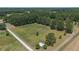 Aerial view of property showing expansive land, trees, and a barn at 113 Amelia Ln, Holly Springs, NC 27540