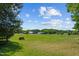 Serene pasture with distant view of farm buildings at 113 Amelia Ln, Holly Springs, NC 27540