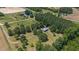 Aerial view of a house on a large lot with surrounding trees and fields at 113 Amelia Ln, Holly Springs, NC 27540