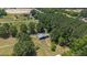 Aerial view of a house on a large lot with surrounding trees and fields at 113 Amelia Ln, Holly Springs, NC 27540