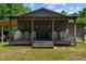 Dark brown exterior with a covered porch and rocking chairs at 113 Amelia Ln, Holly Springs, NC 27540