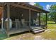 Rustic front porch with rocking chairs, offering a relaxing view of the property at 113 Amelia Ln, Holly Springs, NC 27540