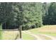 Gravel driveway leading to a wooded area at 8450 Perry Rd, Graham, NC 27253