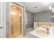 Bathroom with double sinks, shower, and floral wallpaper at 8450 Perry Rd, Graham, NC 27253