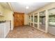 Laundry room with built-in cabinets and sunroom access at 8450 Perry Rd, Graham, NC 27253