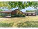 Ranch house with stone accents, carport, and large backyard at 8450 Perry Rd, Graham, NC 27253