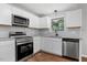 Updated kitchen featuring stainless steel appliances and granite countertops at 1844 Brier Ln, Graham, NC 27253