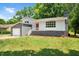 Ranch home with gray and white exterior, red door and attached garage at 1844 Brier Ln, Graham, NC 27253