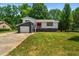 Ranch home with gray and white exterior, red door and attached garage at 1844 Brier Ln, Graham, NC 27253