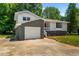 Ranch home with gray and white exterior, red door and attached garage at 1844 Brier Ln, Graham, NC 27253