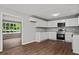 Modern kitchen with white cabinets, granite counters and stainless steel appliances at 1844 Brier Ln, Graham, NC 27253