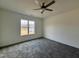 Bright bedroom with gray carpet and a large window at 223 Waterwheel Dr, Selma, NC 27576