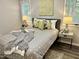 Bedroom with gray bedding, artwork, and side tables at 710 M.L.K. Jr Blvd # F4, Chapel Hill, NC 27514