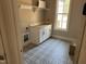 Laundry room with patterned floor and cabinets at 406 Terry Rd, Hillsborough, NC 27278