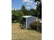 Landscaped backyard with a large storage shed at 970 Southern High School Rd, Graham, NC 27253