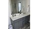 Double vanity bathroom with gray cabinets and a large mirror at 970 Southern High School Rd, Graham, NC 27253