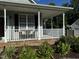 Front porch with white railing and landscaping at 970 Southern High School Rd, Graham, NC 27253