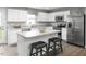 Modern kitchen with white cabinets, stainless steel appliances, and an island at 243 Day Farm Dr, Lillington, NC 27546