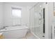 Clean bathroom with a soaking tub and a separate walk-in shower at 617 Tower St, Raleigh, NC 27607