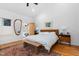 Bright main bedroom with a large bed, hardwood floors, and plenty of natural light at 617 Tower St, Raleigh, NC 27607