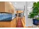 Modern kitchen with wood cabinets, granite counters, and stainless steel appliances at 617 Tower St, Raleigh, NC 27607