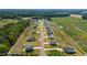 Aerial view of a new home community with several houses and open green spaces at 91 Walker Grove Ln, Lillington, NC 27546