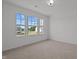 Bright bedroom with three windows and carpet at 91 Walker Grove Ln, Lillington, NC 27546
