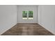Well-lit bedroom with hardwood floors and large windows at 91 Walker Grove Ln, Lillington, NC 27546