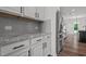 White shaker cabinets, granite counters and stainless steel refrigerator at 91 Walker Grove Ln, Lillington, NC 27546