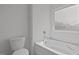 Bathroom with bathtub and window at 91 Walker Grove Ln, Lillington, NC 27546