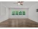 Spacious living room with hardwood floors and multiple windows at 91 Walker Grove Ln, Lillington, NC 27546