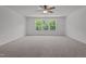 Spacious bedroom with ceiling fan and large windows at 91 Walker Grove Ln, Lillington, NC 27546