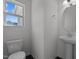 Clean bathroom with pedestal sink, toilet and shower/tub combo at 91 Walker Grove Ln, Lillington, NC 27546