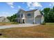Two-story house exterior with a two-car garage and landscaping at 91 Walker Grove Ln, Lillington, NC 27546