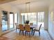 Bright dining room features a wooden table, tan chairs, and access to the backyard at 7645 Falls Creek Ln, Raleigh, NC 27614