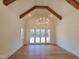 Spacious main bedroom with hardwood floors, large windows, and a stunning chandelier at 7645 Falls Creek Ln, Raleigh, NC 27614