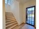 Modern light oak staircase with a metal railing at 7645 Falls Creek Ln, Raleigh, NC 27614