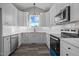 Modern kitchen with white cabinets and stainless steel appliances at 531 Booth St, Roxboro, NC 27573