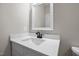 Clean bathroom with white vanity, sink, and a mirror at 531 Booth St, Roxboro, NC 27573