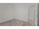 Bright bedroom with grey wood-look floors and access to a bathroom at 531 Booth St, Roxboro, NC 27573