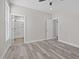 Bedroom with wood-look floors, access to bathroom, and ceiling fan at 531 Booth St, Roxboro, NC 27573