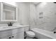 Modern bathroom with white cabinets, marble tile, and a bathtub at 531 Booth St, Roxboro, NC 27573