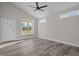 Open concept living room with gray vinyl flooring and large window at 531 Booth St, Roxboro, NC 27573