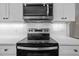 Stainless steel range and microwave in a modern kitchen at 531 Booth St, Roxboro, NC 27573